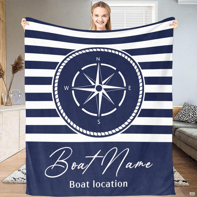 Nautical bedding set featuring a circular compass rose and navy sailor stripes in a modern bedroom setting.