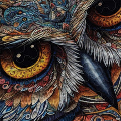 Close-up view of owl bedding highlighting detailed silver plumage, sharp beak, and glowing nocturnal eyes