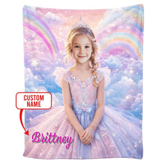 Folded blanket showing pastel pink clouds, sparkling stars, and rainbow arc design.