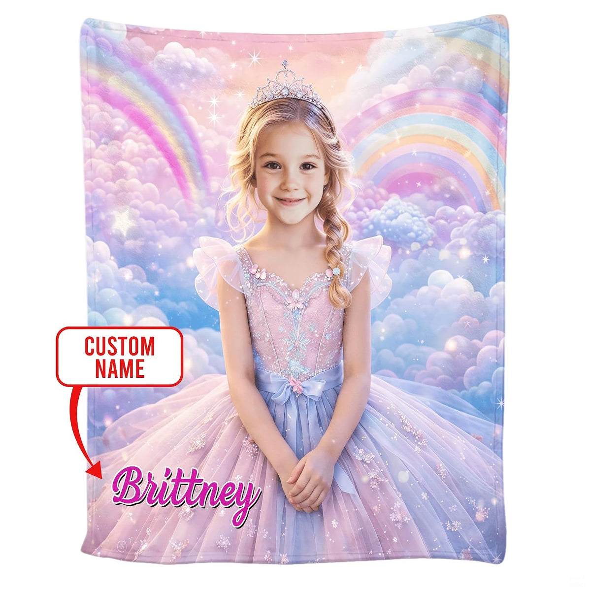 Folded blanket showing pastel pink clouds, sparkling stars, and rainbow arc design.