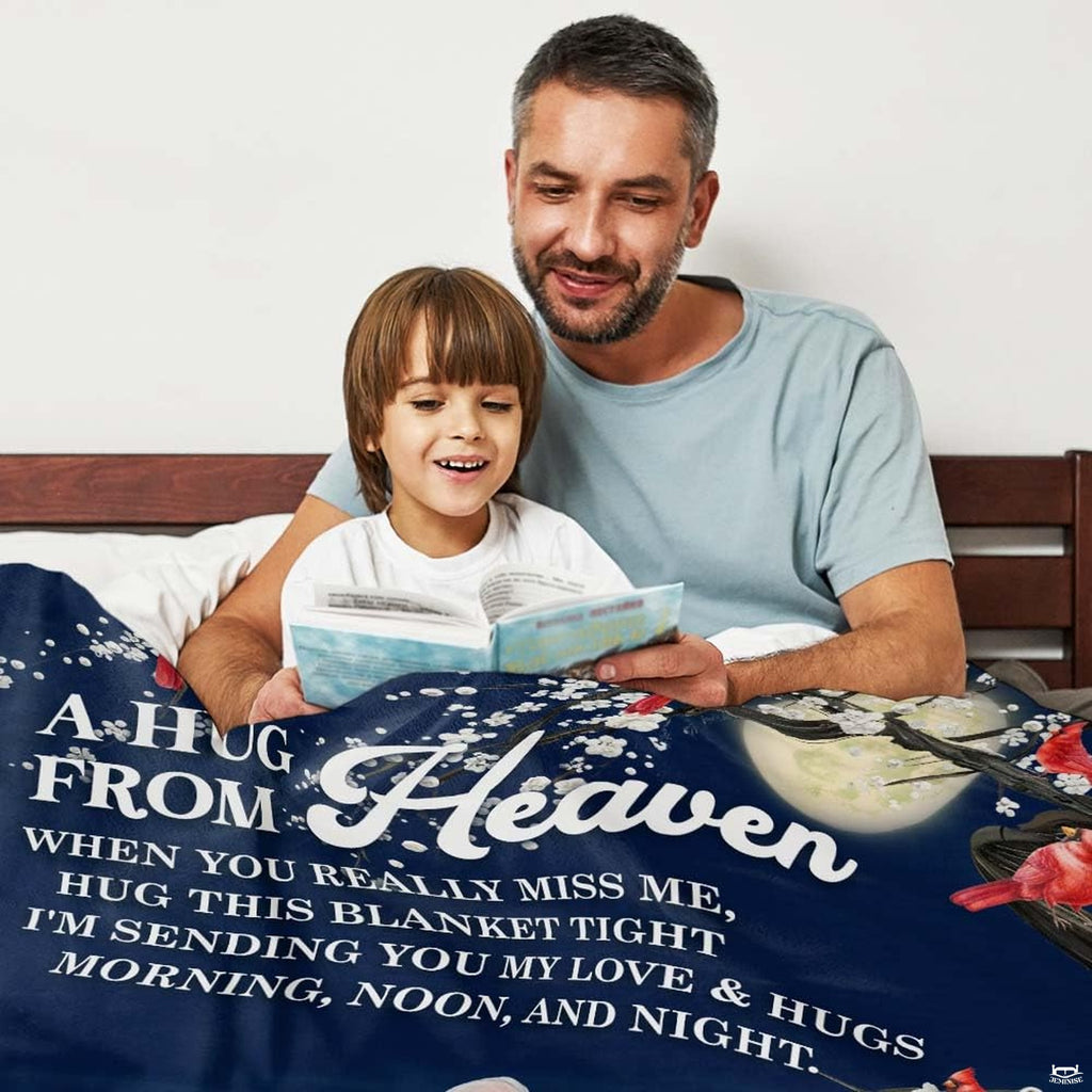 Close-up perspective of red cardinals on blossoming branch on memorial throw blanket