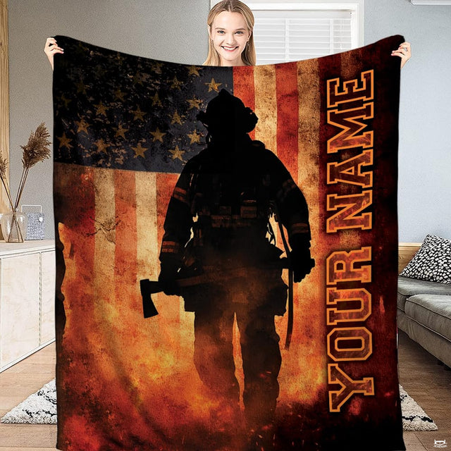 Firefighter silhouette holding axe against distressed American flag with rising embers on Blanket.