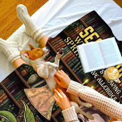 Overhead bedroom scene with resting dog and coffee mug beside the displayed literary textile.