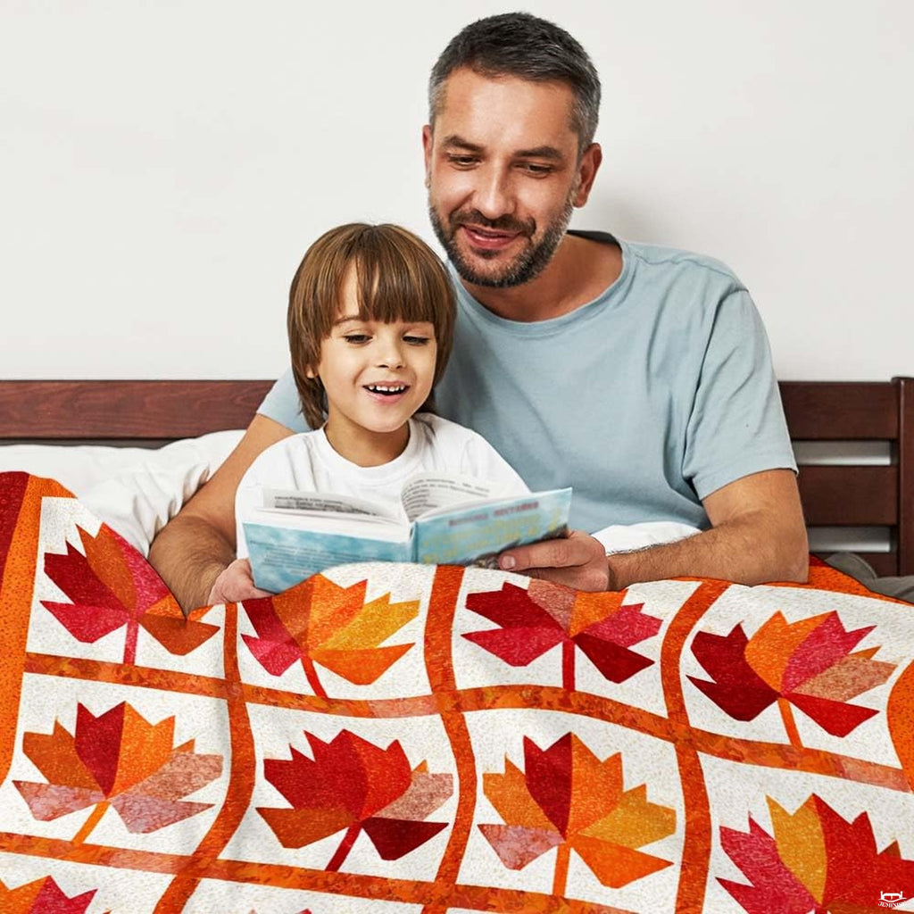 Detailed look at speckled off-white panel texture and burnt orange grid sashing on decorative throw