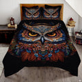 Moonlit silver and sapphire owl wildlife bedding set displayed neatly on a bed in a modern bedroom
