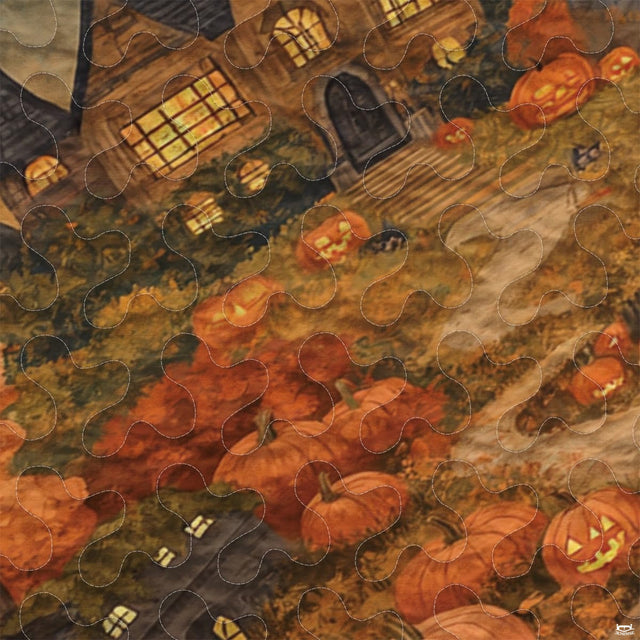 Close-up perspective of Halloween bedding showing detailed carved pumpkin faces and glowing windows