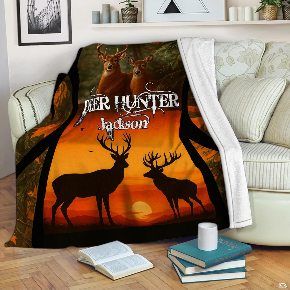 Rustic whitetail sunset blanket draped across an indoor living room couch next to a stack of books.