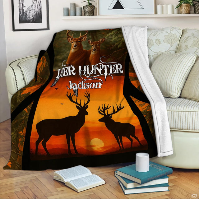 Rustic whitetail sunset blanket draped across an indoor living room couch next to a stack of books.
