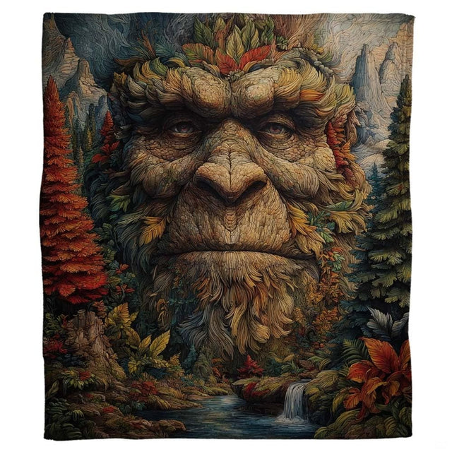 Bigfoot forest spirit throw blanket view 2 highlighting Sasquatch facial artwork and autumn woodland foliage