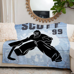 Hockey goalie silhouette sports blanket styled neatly across an ivory living room couch.