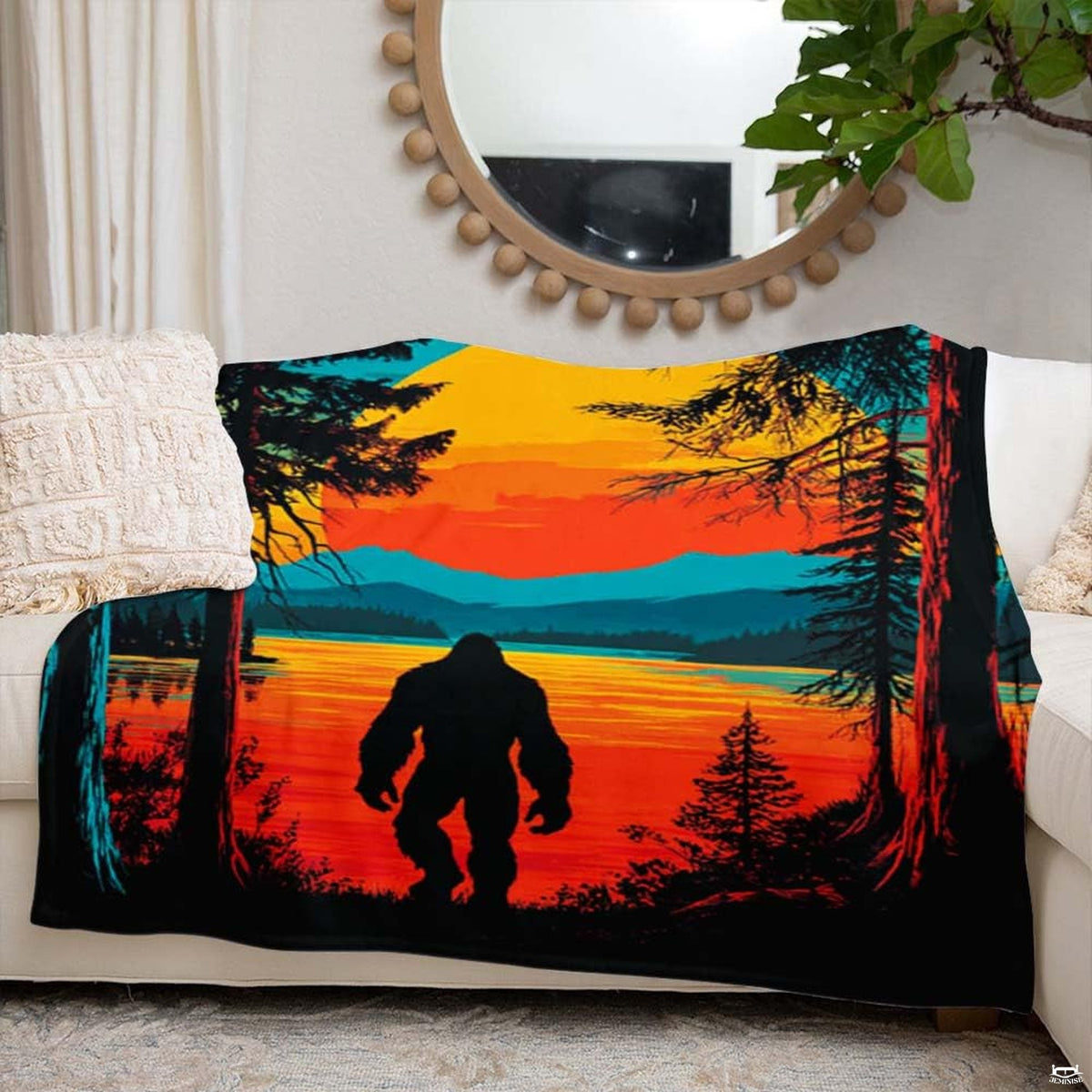 Bigfoot lakeside sunset throw blanket styled over a bed in a modern bedroom setting