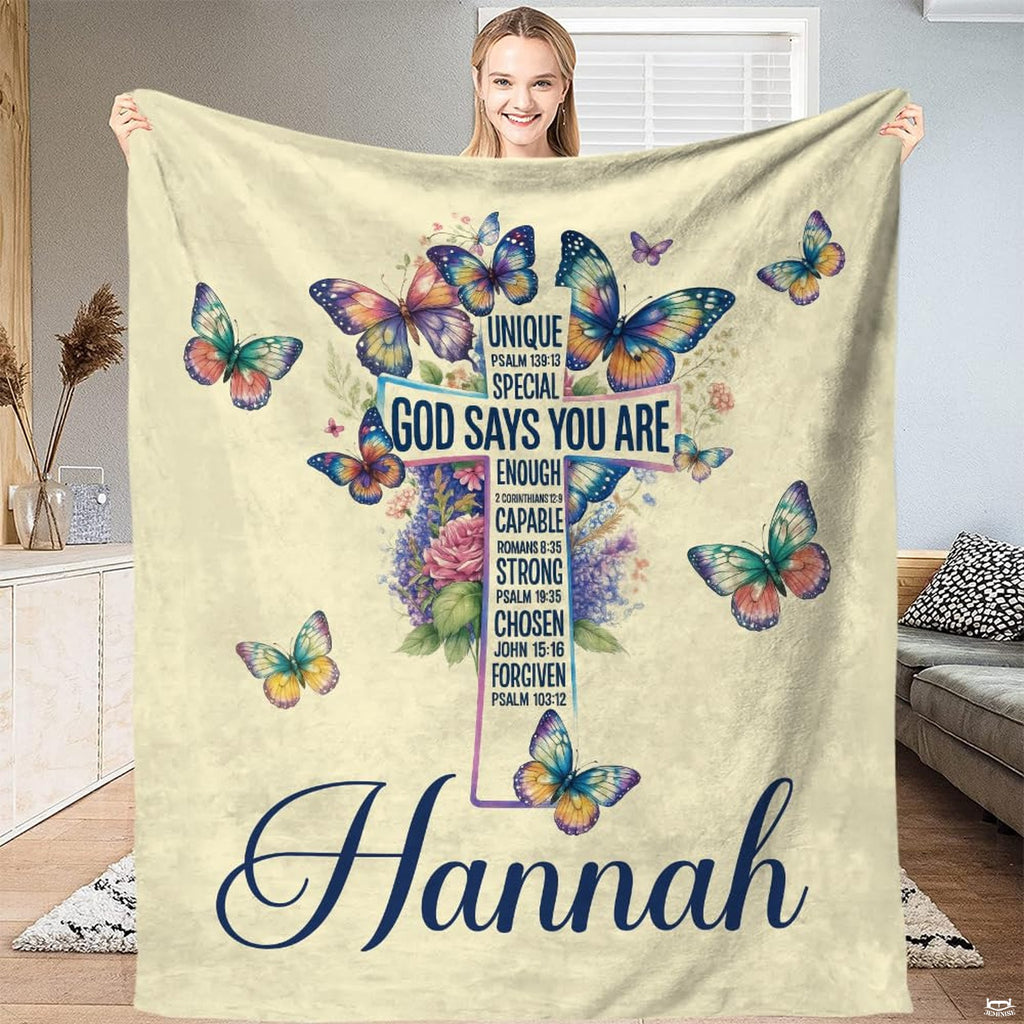 Artistic bedroom presentation of whimsical botanical cross and butterfly print.