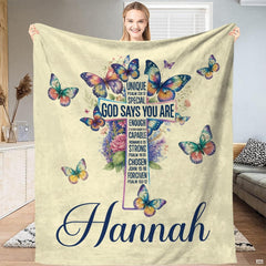 Artistic bedroom presentation of whimsical botanical cross and butterfly print.