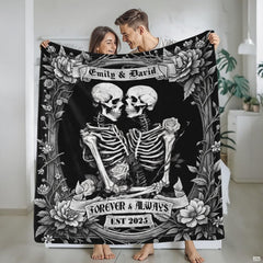 Detailed monochrome illustration of skeleton lovers framed by vintage roses and ribbon banners.