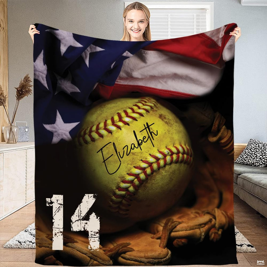 Woman holding up rectangular softball blanket displaying patriotic sports and flag design