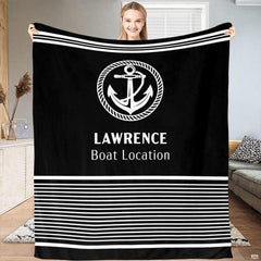 Person holding up the black and white nautical anchor print with horizontal stripes.