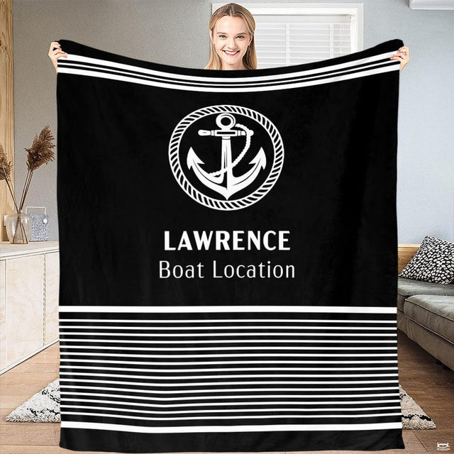 Person holding up the black and white nautical anchor print with horizontal stripes.