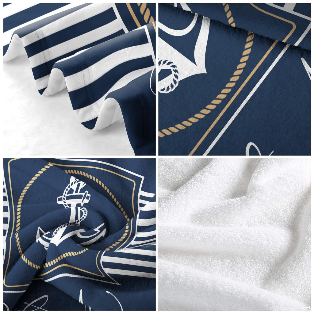 Side angle view of nautical navy blue coastal bedding styled in a seaside master suite.