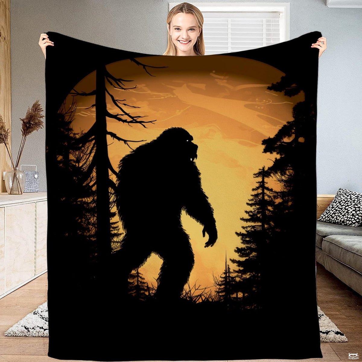 Bigfoot amber moon blanket featuring Sasquatch silhouette and pine trees within glowing vignette.