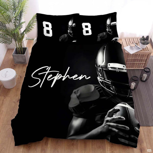 Monochrome football bedding displaying poised quarterback in gloss helmet holding game ball against black background