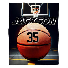 Basketball bedding displaying textured ball on polished indoor hardwood court with dramatic overhead spotlights.