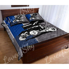 Motorsport race car bedding toddler room display with diagonal speed stripes, halftone gradients, and skyline backdrop.