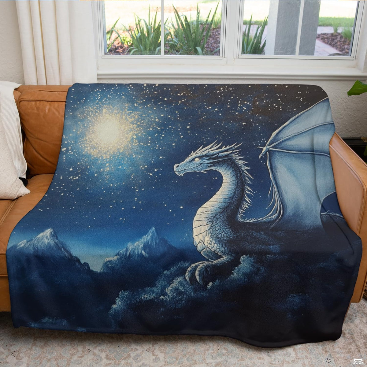 Artistic bedding display featuring an ice dragon illustration amidst constellations and snowy mountain peaks.