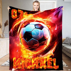Person displaying the fiery soccer ball vortex artwork with cyan highlights.
