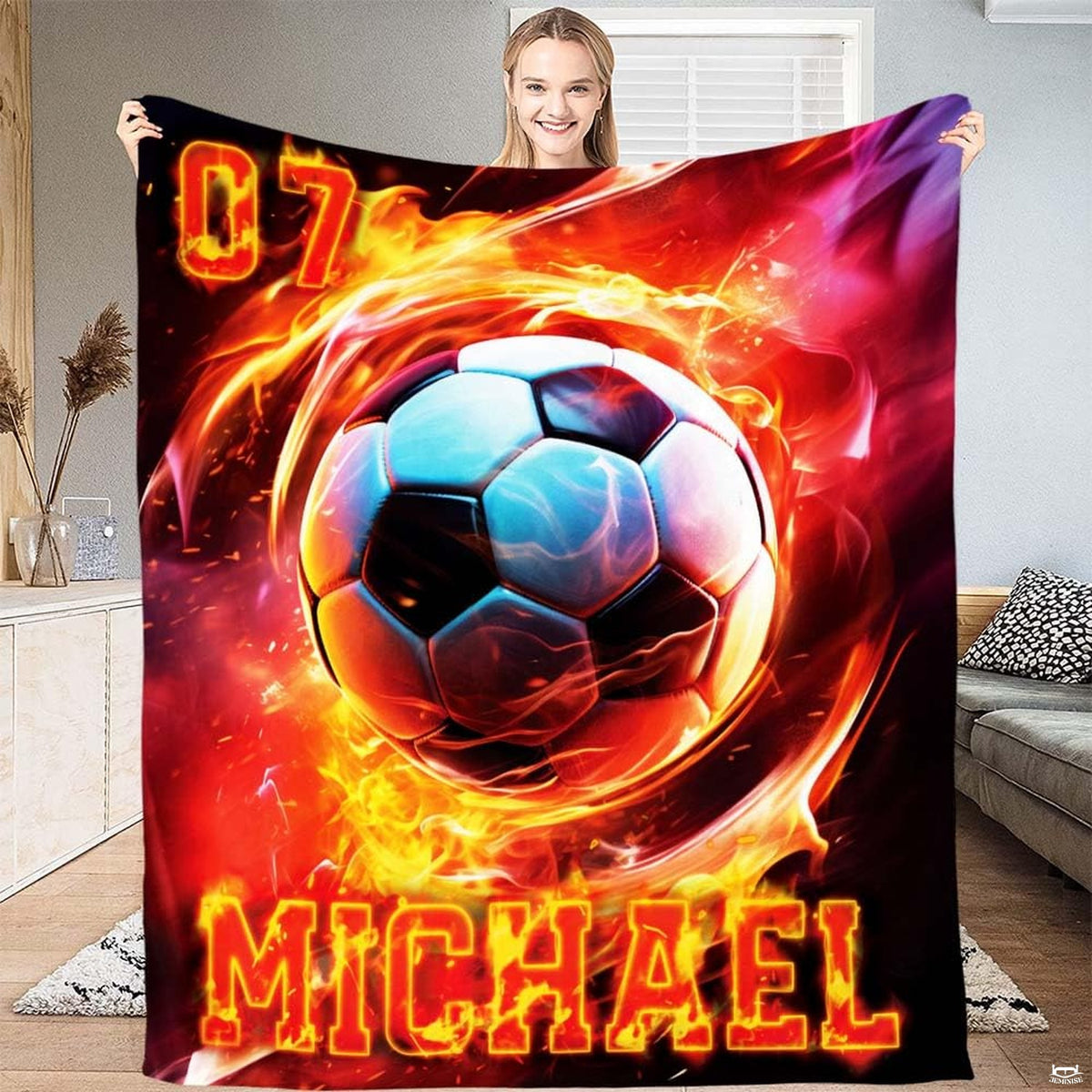 Person displaying the fiery soccer ball vortex artwork with cyan highlights.