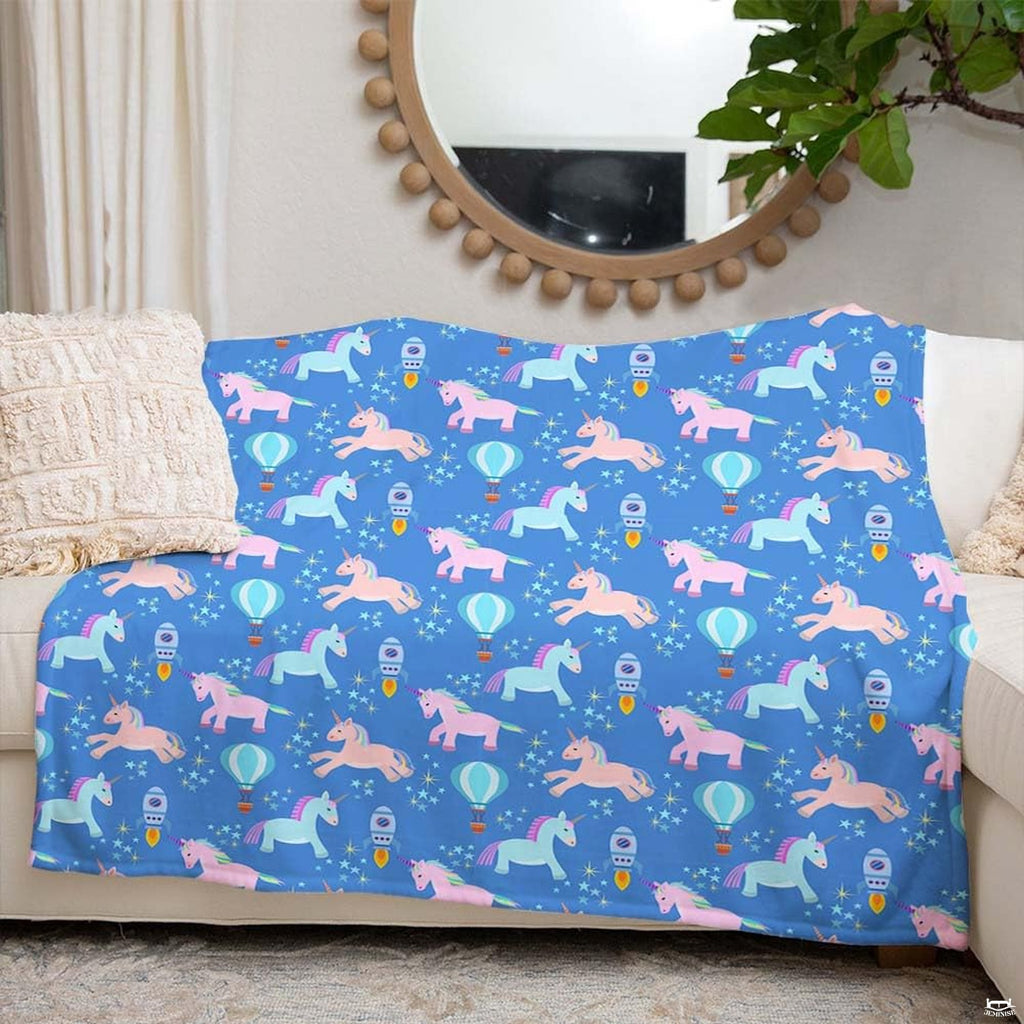 Close-up of pastel pink unicorn illustration with colorful mane and golden horn on starry royal blue background.