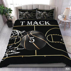 Black and gold basketball court sports bedding set spread over a bed with golden court lines.