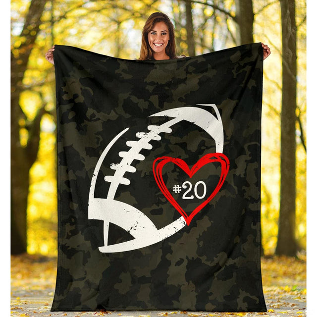 Close view of distressed football stencil and red heart on blanket