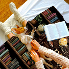 Bookworm girl throw blanket view 4 highlighting reader character, wooden library shelves, and houseplants