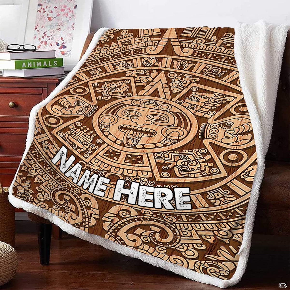 Woodgrain sun calendar graphic textile draped over armchair beside reading books.