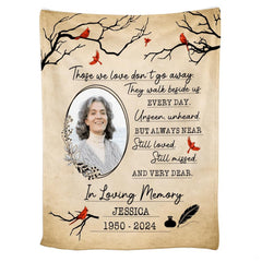 Cardinal memorial throw blanket draped over a living room couch