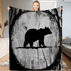 Rustic tree ring bear silhouette throw blanket featuring bear silhouette inside circular wood cross section