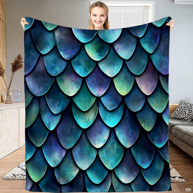 Overhead display of iridescent dragon scale bedding showing teal, emerald green, and cobalt blue scales.