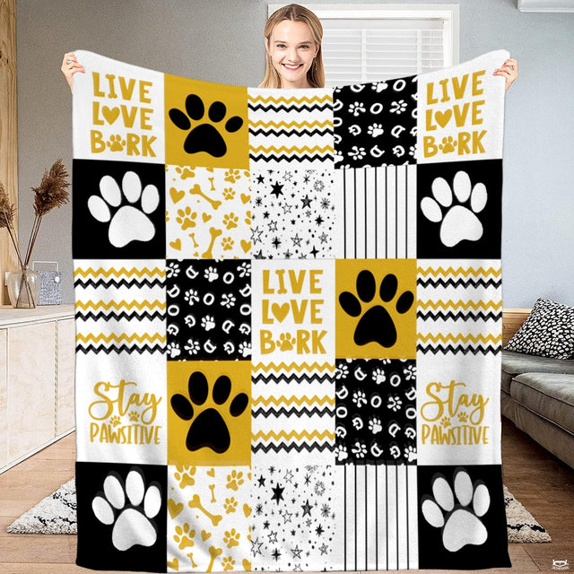 Golden dog paw print patchwork throw blanket with bold puppy paws and chevron zigzag blocks