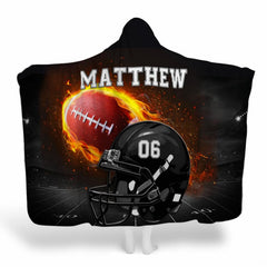 Flaming football helmet stadium throw blanket displaying black helmet and blazing football under lights