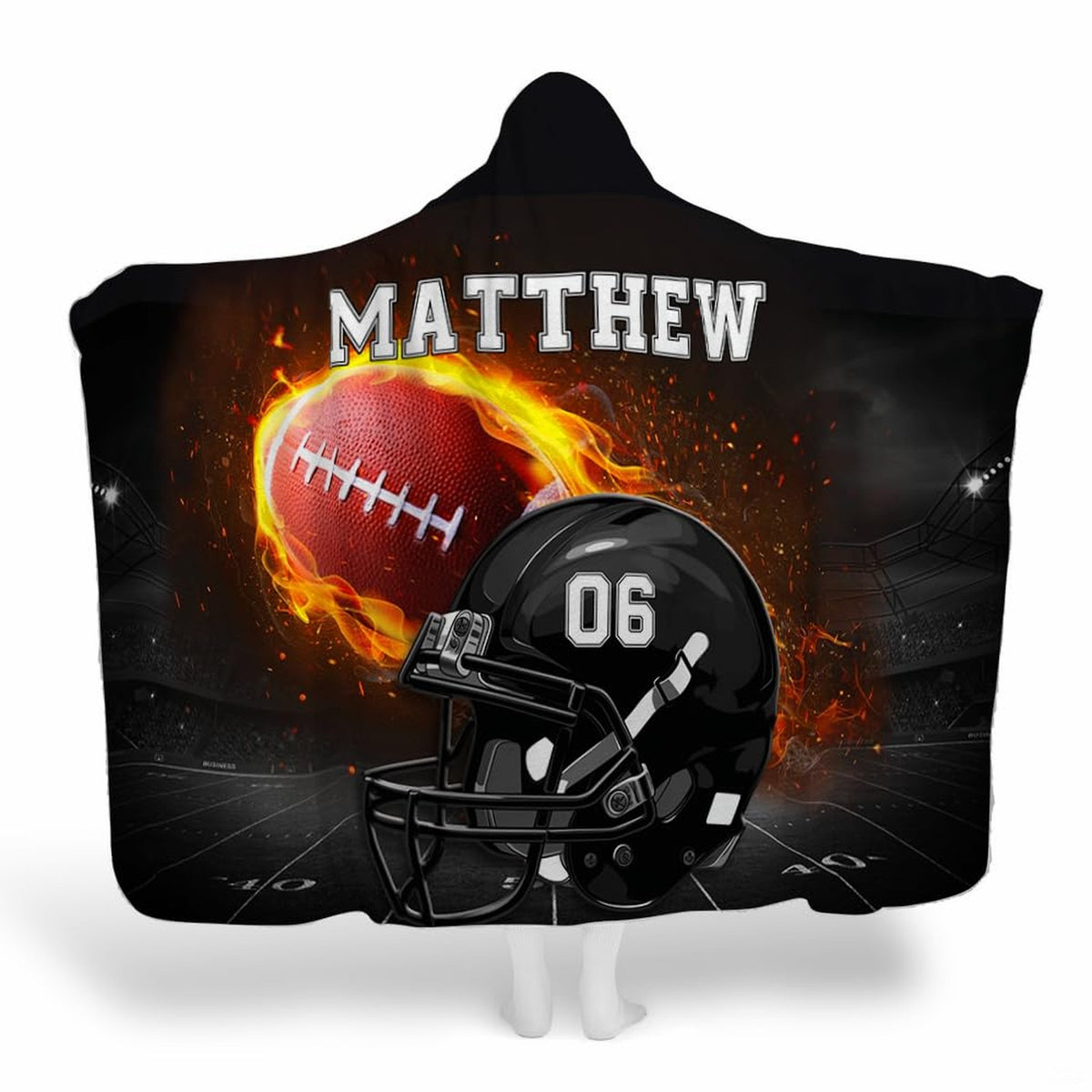 Flaming football helmet stadium throw blanket displaying black helmet and blazing football under lights
