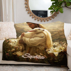 Good Shepherd Jesus blanket draped over an ivory couch beneath an ornate wall mirror.
