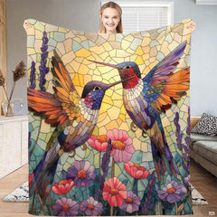 Stained glass mosaic blanket featuring two hummingbirds above blooming garden flowers.