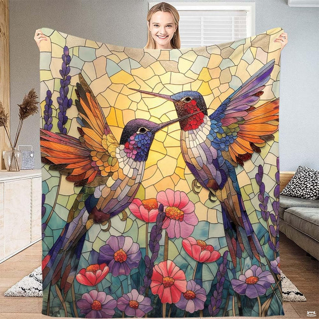 Stained glass mosaic blanket featuring two hummingbirds above blooming garden flowers.