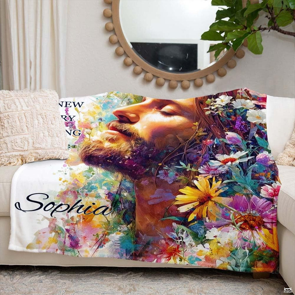 Jesus Christ floral blanket styled neatly across an ivory living room couch.