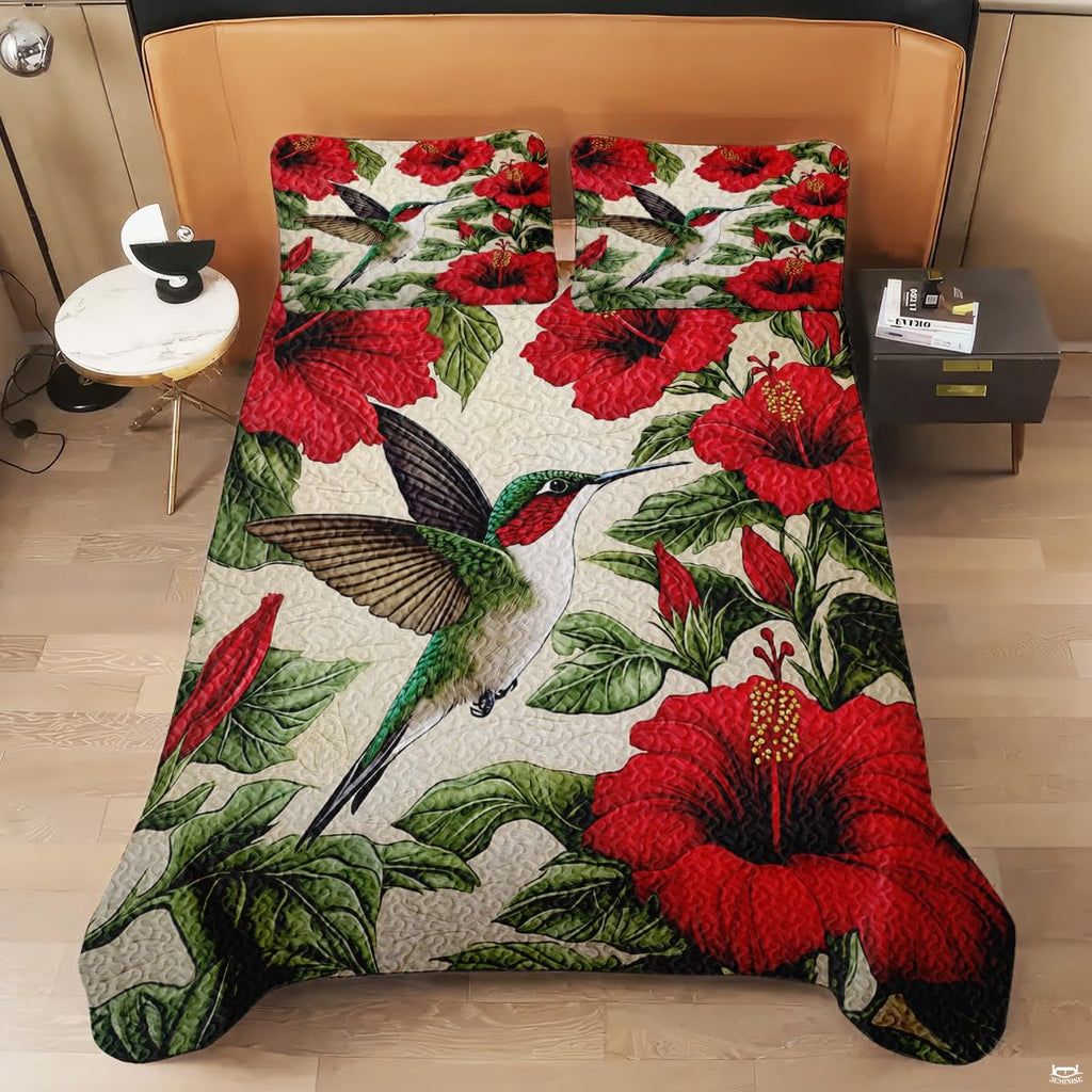 Overhead view of hummingbird bedding with large scarlet hibiscus flowers