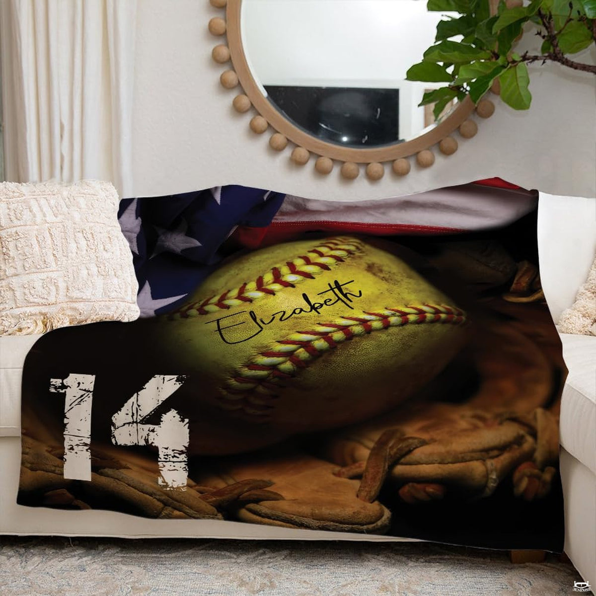 Softball sports blanket arranged neatly over white sofa in bright living room