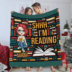 Living room staging displaying geometric bookshelf throw blanket draped over furniture.