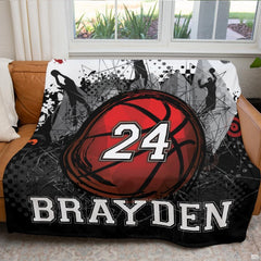 Detailed view of grunge paint splatters and athletic dunking player silhouettes on bedding print.