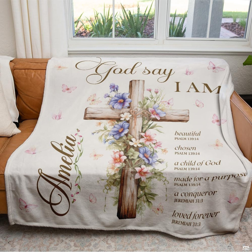 Close-up perspective of timber cross and purple floral blossoms on throw blanket