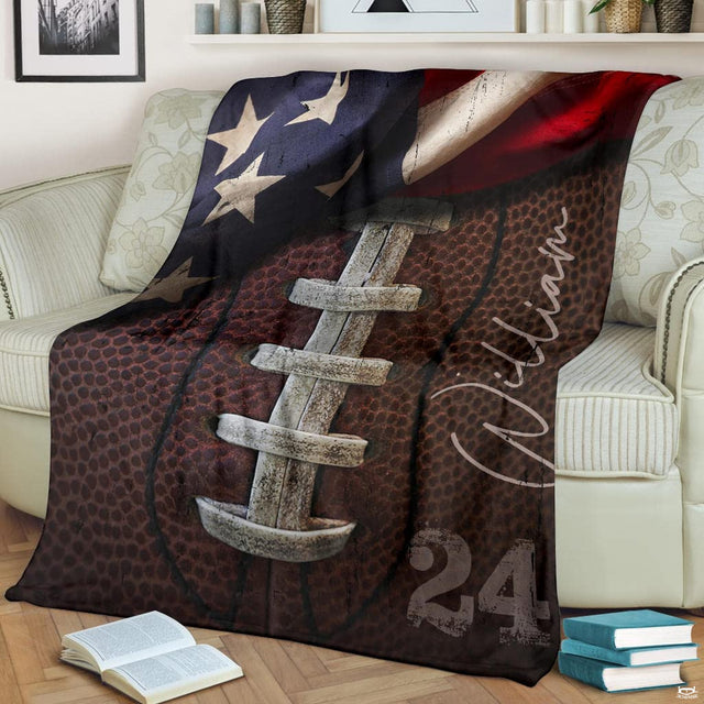 Vintage patriotic gridiron laced football blanket draped over sofa